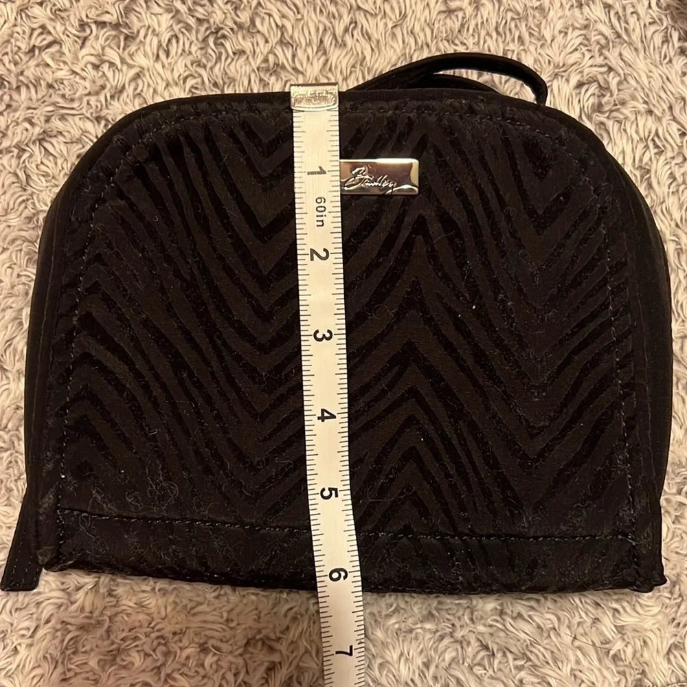 Vera Bradley black toiletry bag with 4 zippered pockets inside. Great condition!